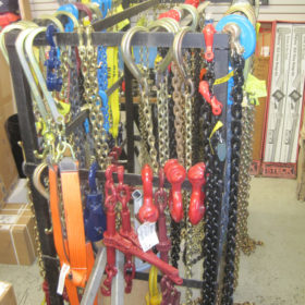 A rack of chains and hooks for sale.