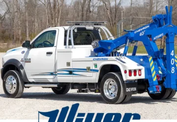 White tow truck with blue Chevron logo.