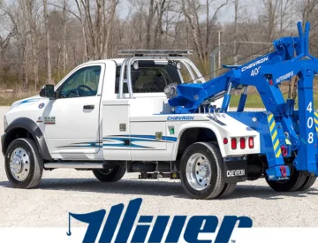 White tow truck with blue Chevron logo.