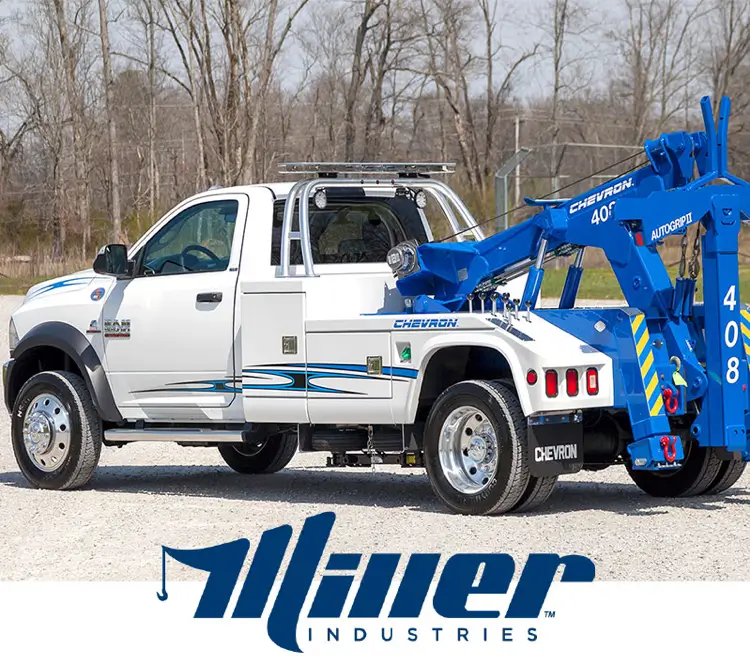 White tow truck with blue Chevron logo.