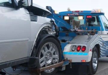 Tow truck towing a damaged car.