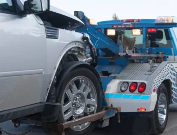 Tow truck towing a damaged car.