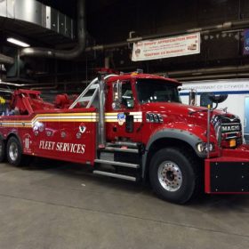 A red tow truck parked in a garage.