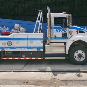 A tow truck parked on the side of the road.